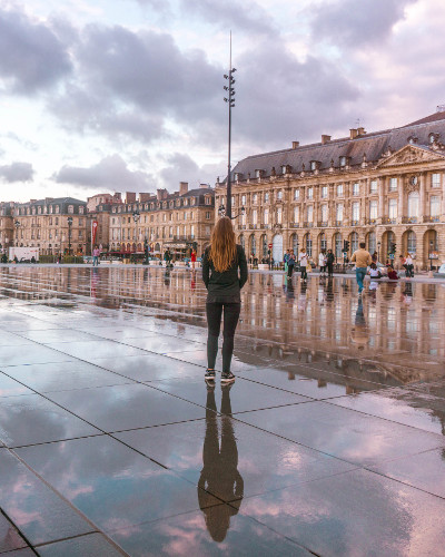 Reflection at Miroir d'Eau during sunset in Bordeaux, France